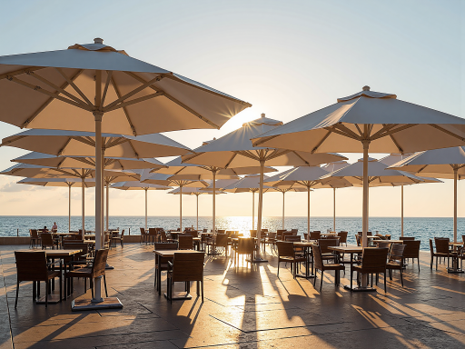 Large market umbrella showing white canopy with wooden pole, installed on outdoor table, classic design suitable for restaurants